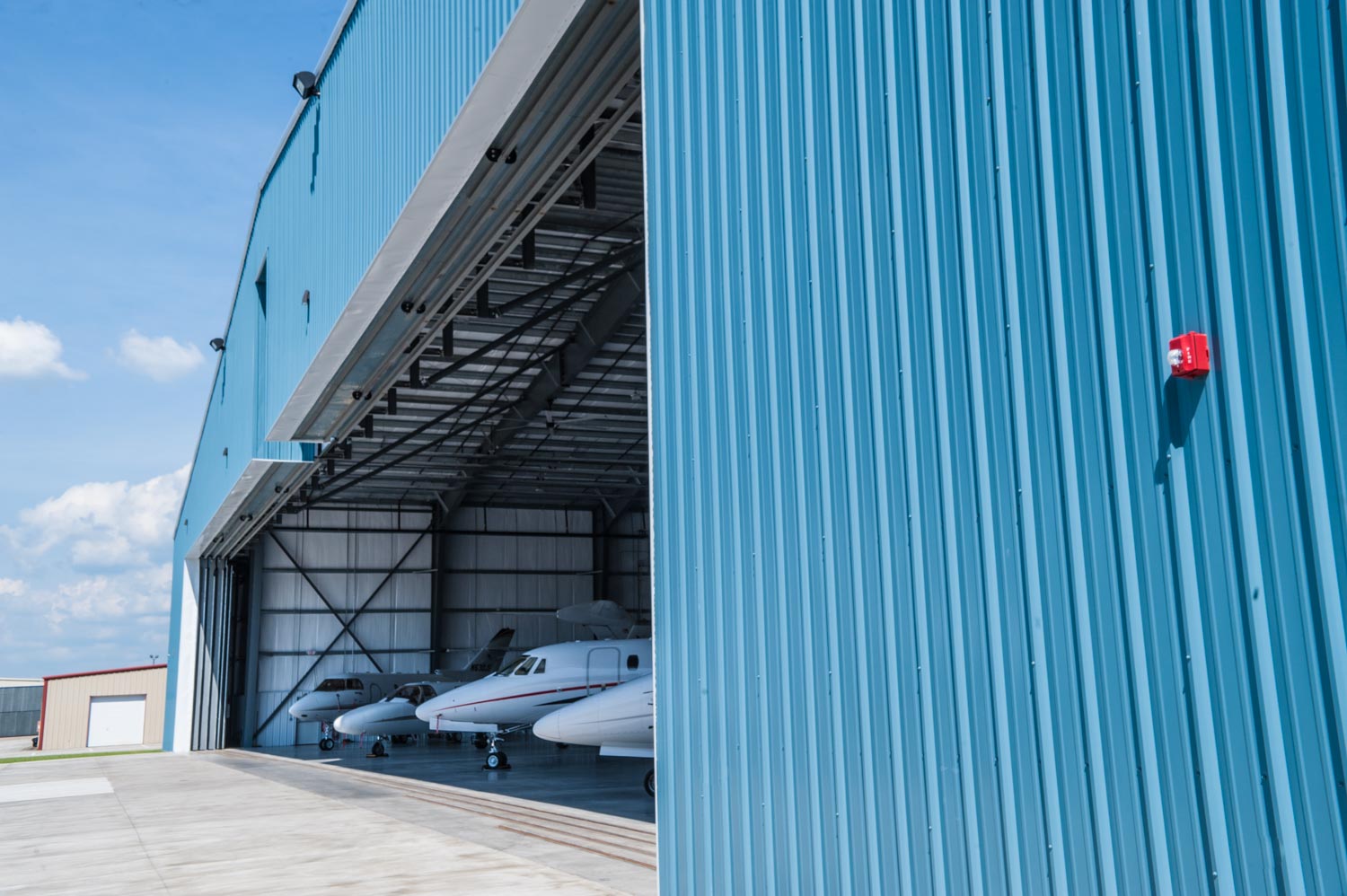 Photo of outside custom airplane hanger doors Lj & Associates
